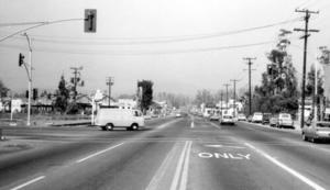 Black and white picture of a white van in the intersection of Newport Ave. at First St., Tustin, April 1966